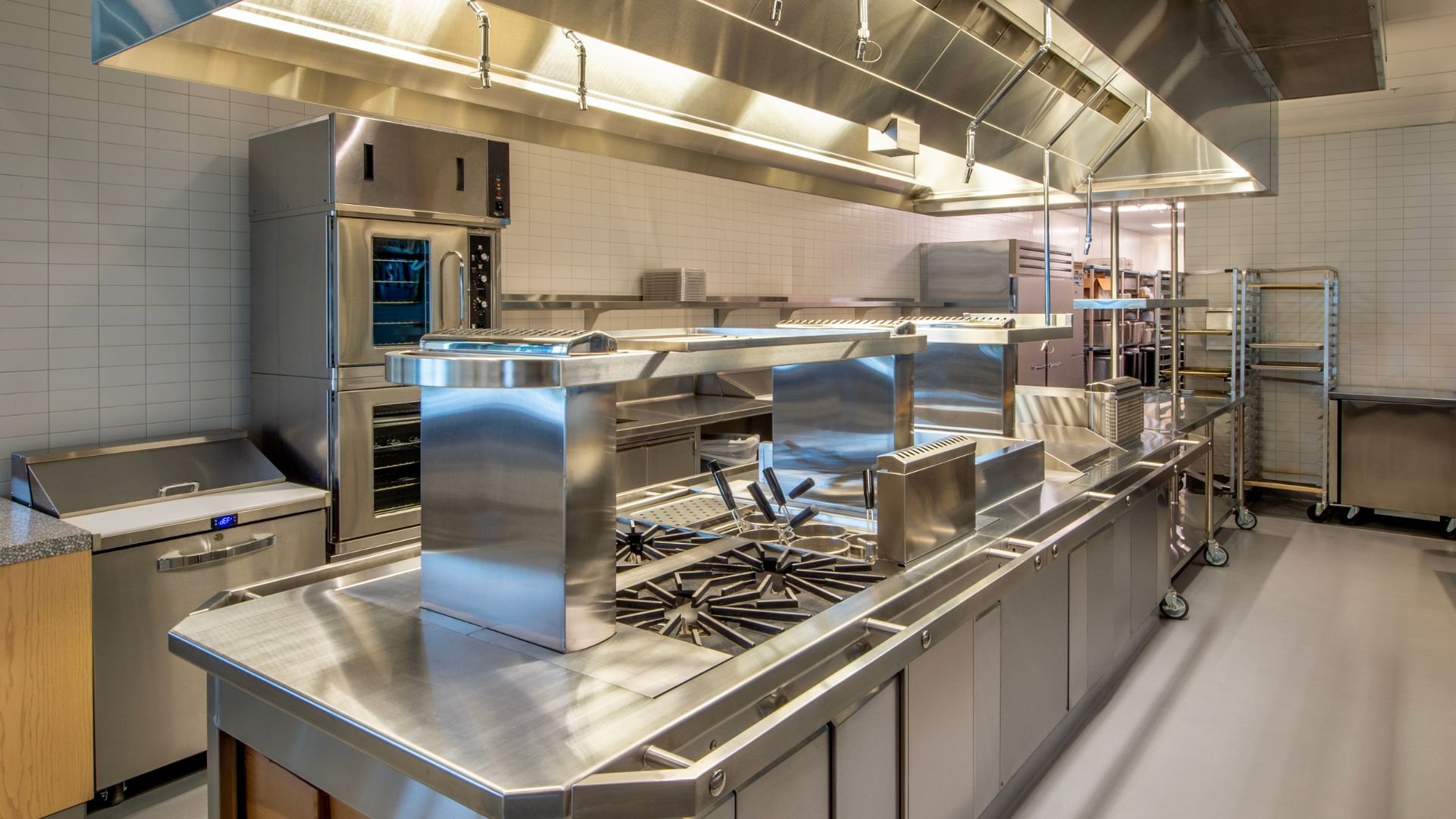 Professional commercial kitchen with stainless steel appliances and cooking stations